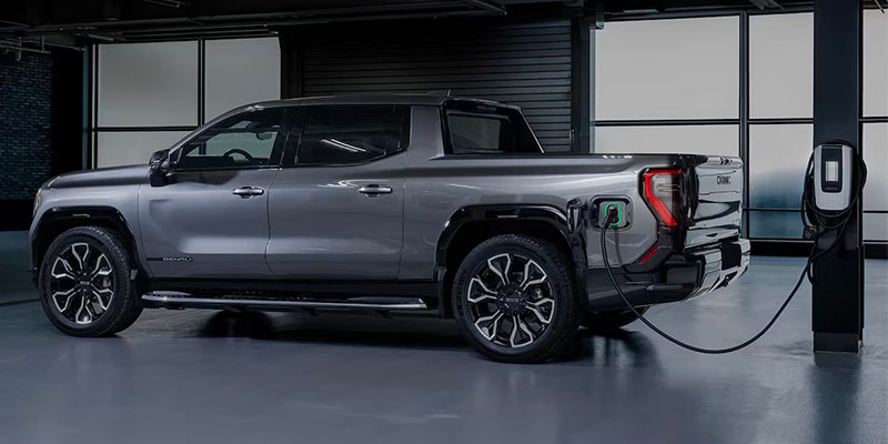 Gray colored rear driver side angle of the 2025 Sierra EV.